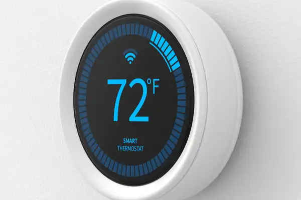 Smart thermostat displaying 72°F with a Wi-Fi symbol on a circular screen.